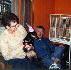 Emme (dachshund) with Sue and Joe (people)
