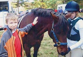 two riding students with horse