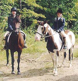 two riding students on horseback